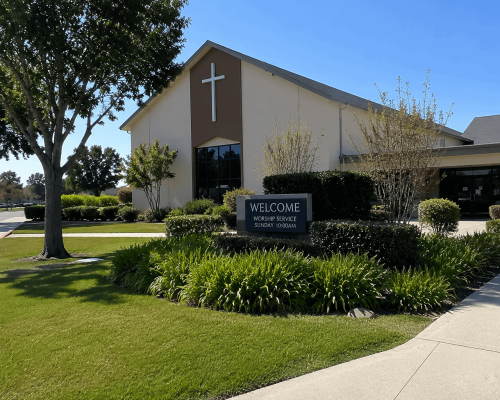 Church with professionally maintained commercial landscaping in Oakland, CA featuring healthy lawns, trees, shrubs, and clean walkways.